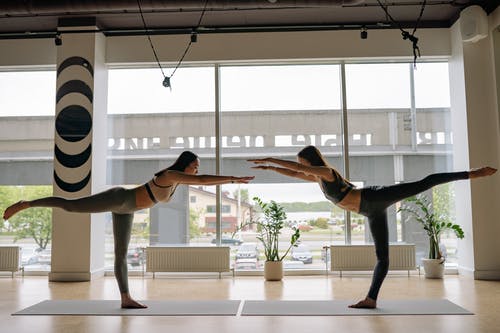 Two girls doings a yoga pose